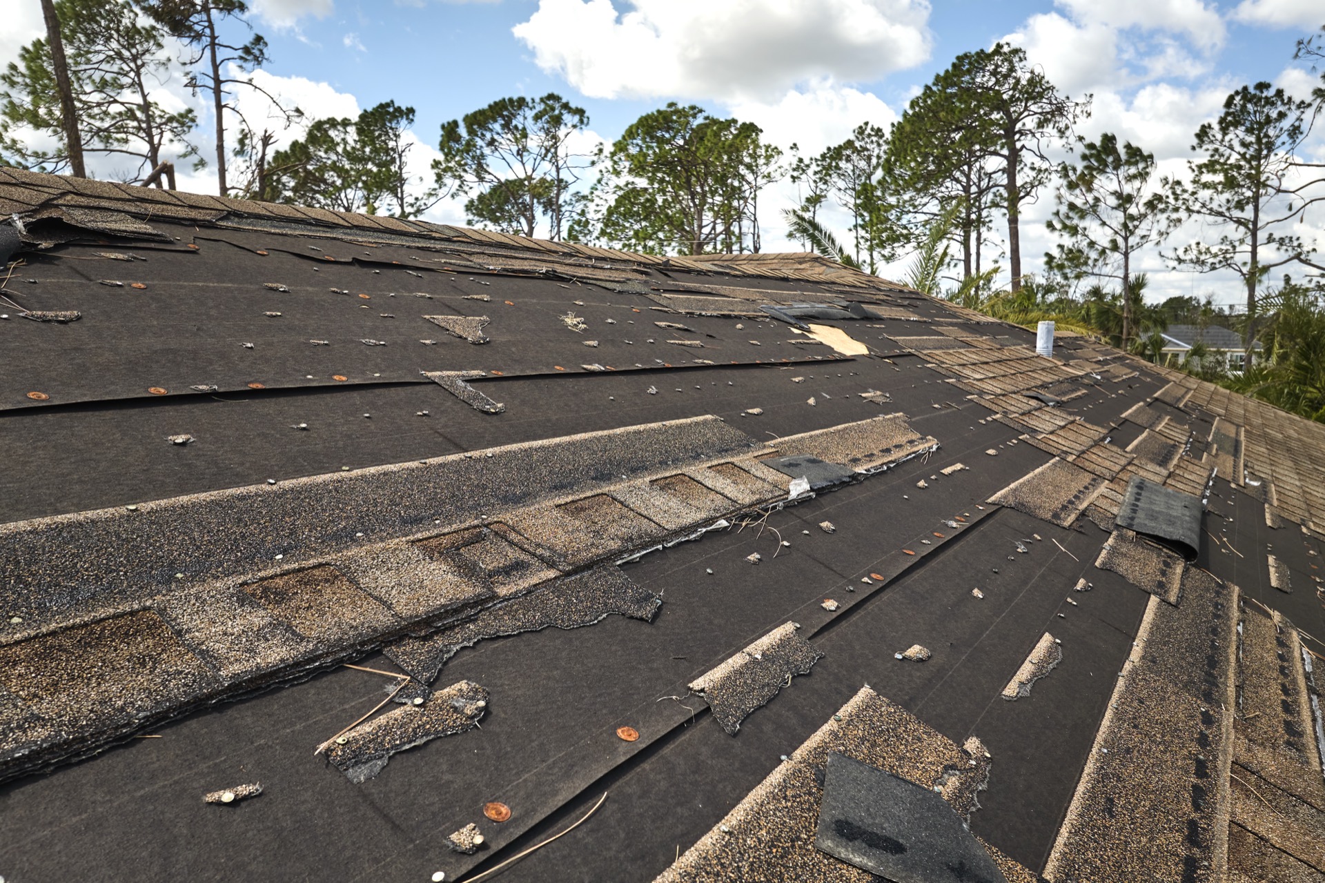Storm-damaged roof with missing shingles